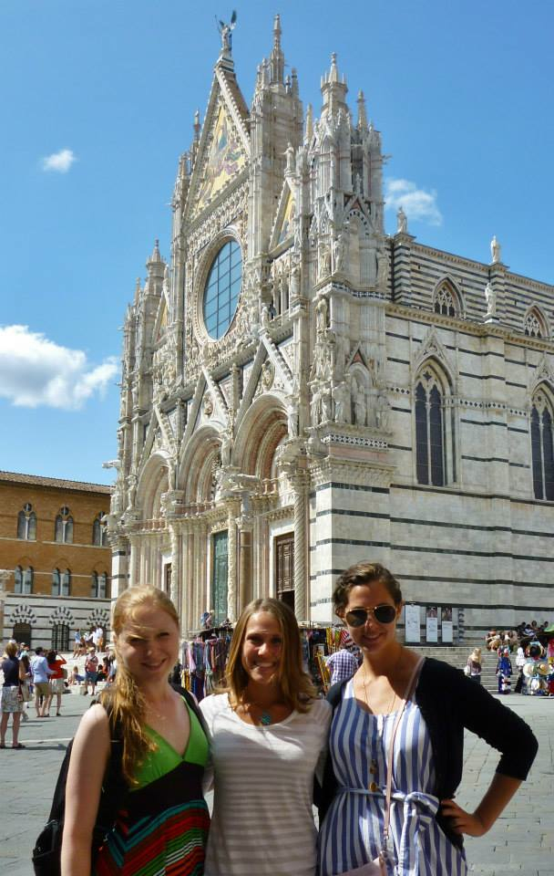 three UA students pose in front of a cathedral