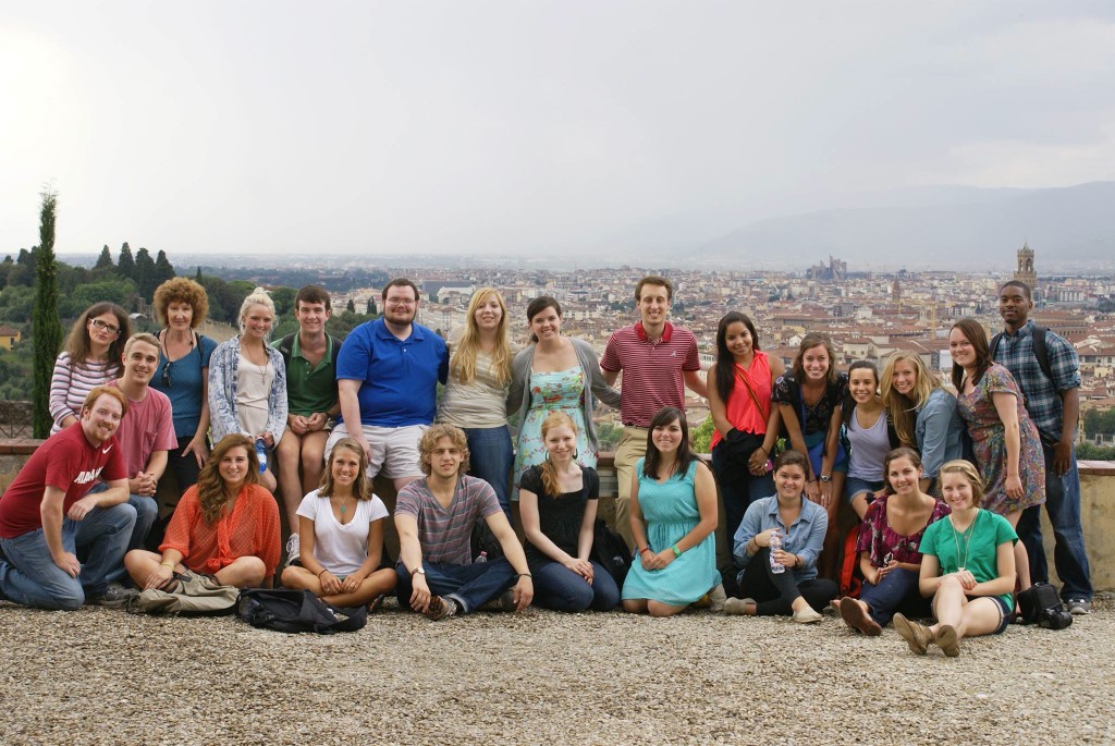 a group of UA students poses atop a hill overlooking Florence, Italy