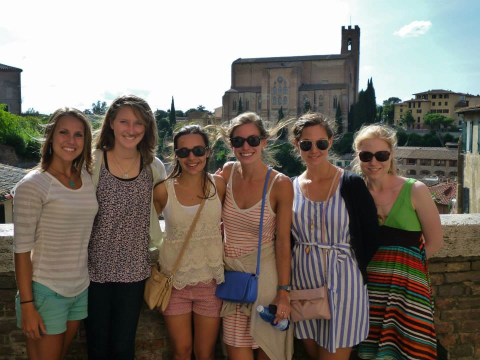 six UA students pose in front of a large building in Florence, Italy