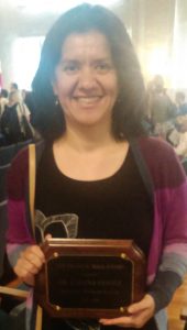 Lorena Gomez, holding a plaque