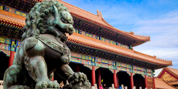 bronze lion statue in front of an imperial hall in China